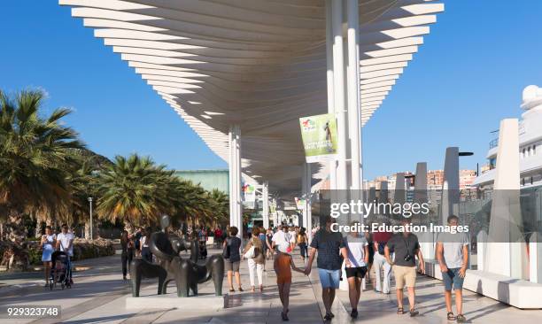 Malaga, Costa del Sol, Malaga Province, Andalusia, southern Spain, People strolling beneath the Paseo de la Pergola on Muelle Uno.