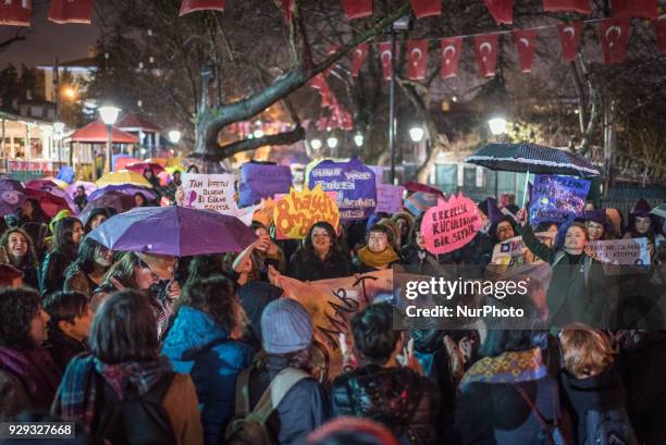 Women in Ankara, Turkey, gather at night in Kugulu Park under rainy weather to make speeches, protest and dance in recognition of International...