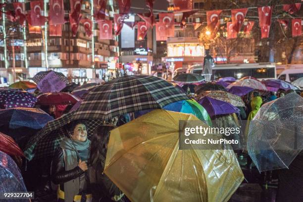 Women in Ankara, Turkey, gather at night in Kugulu Park under rainy weather to make speeches, protest and dance in recognition of International...