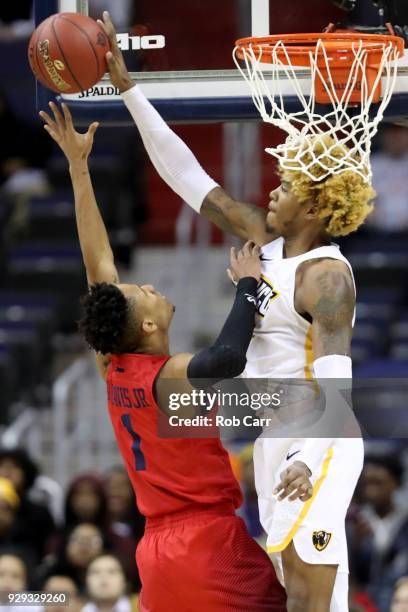 Justin Tillman of the Virginia Commonwealth Rams blocks a shot by Darrell Davis of the Dayton Flyers in the second half during the second round of...