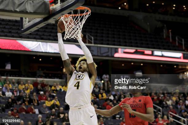Justin Tillman of the Virginia Commonwealth Rams dunks the ball in front of Kostas Antetokounmpo of the Dayton Flyers in the second half during the...