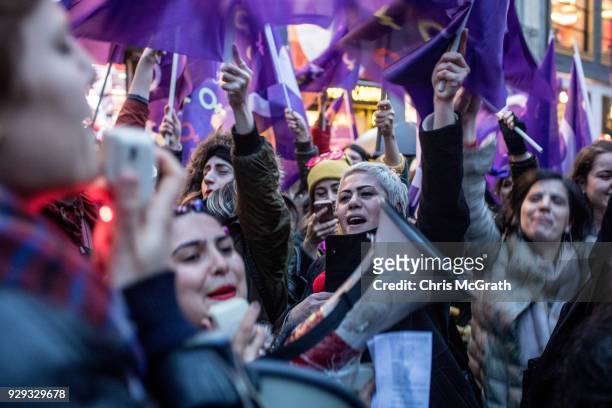 People chant slogans as they march down Istanbul's famous Istiklal street during a rally for International Women's Day on March 8, 2018 in Istanbul,...