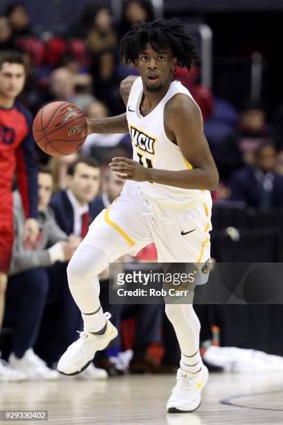 Issac Vann of the Virginia Commonwealth Rams dribbles the ball against the Dayton Flyers in the second half during the second round of the Atlantic...
