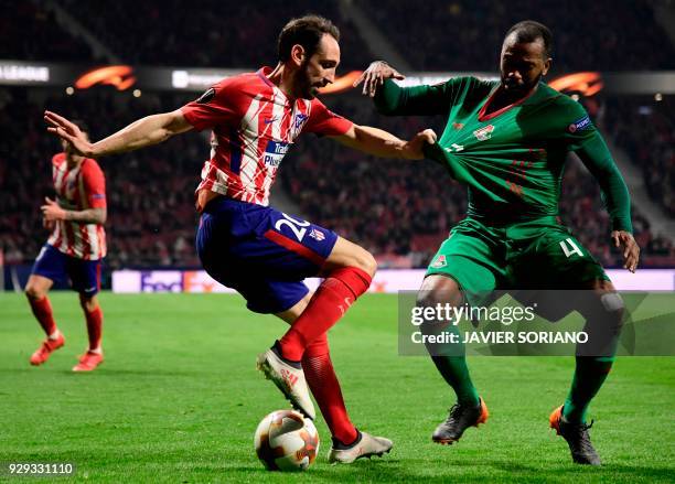 Atletico Madrid's Spanish defender Juanfran vies with Lokomotiv Moscow's Portuguese midfielder Manuel Fernandes during the Europa League Round of 16...