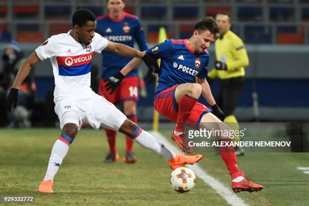 Lyon's French forward Myziane Maolida and CSKA Moscow's midfielder from Russia Aleksandr Golovin vie for the ball during the UEFA Europa League round...