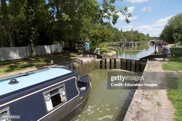 Canal boat passing through a lock on the Caen Hill Flight of locks at Devizes Wiltshire, England UK.