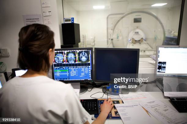 Medical imaging service in a hospital in Savoie, France. A technician monitors a brain MRI scan session.