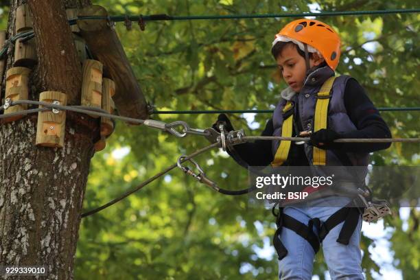 Year-old boy on a rope course. France.