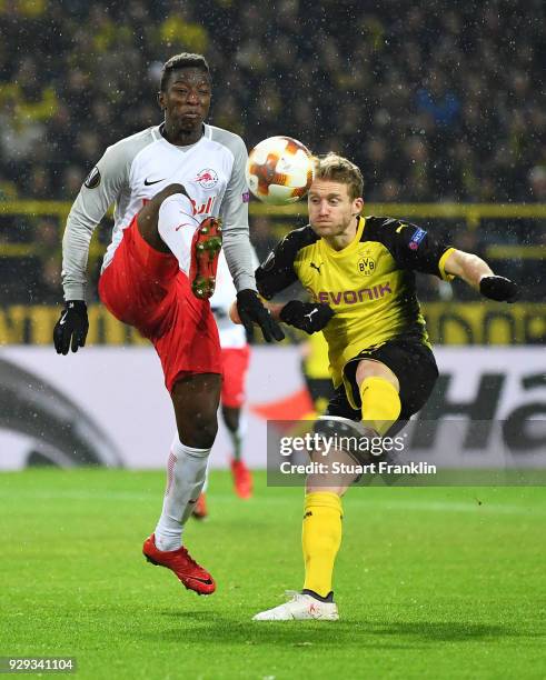 Amadou Haidara of Red Bull Salzburg and Andre Schuerrle of Borussia Dortmund battle for the ball during the UEFA Europa League Round of 16 match...