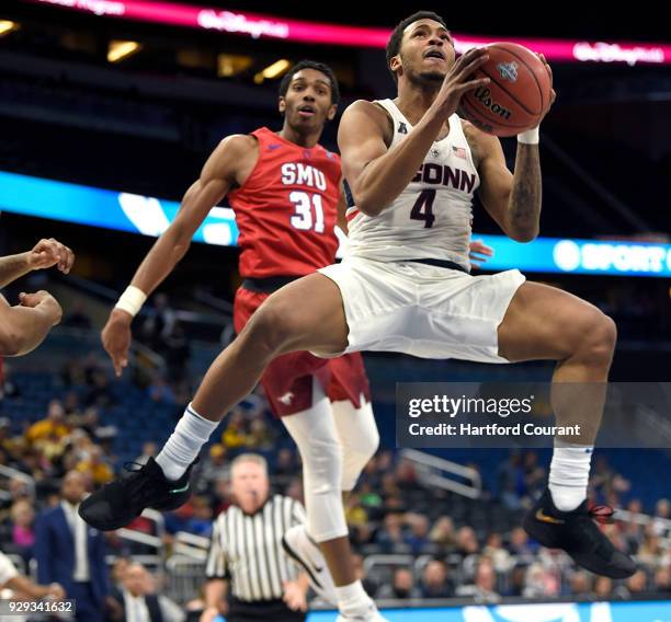 Connecticut Huskies guard Jalen Adams floats to the basket past Southern Methodist Mustangs guard Jimmy Whitt in a first round game at the 2018...