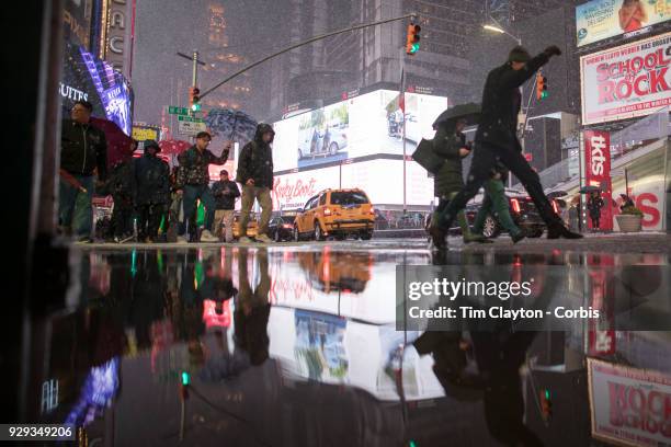 Commuters navigate the deluge from Winter Storm Quinn near Time Square, Manhattan, New York on March 7, 2018 New York City.