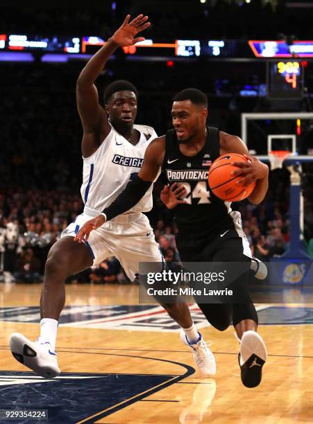 Kyron Cartwright of the Providence Friars handles the ball against Khyri Thomas of the Creighton Bluejays in the first half during the Big East...