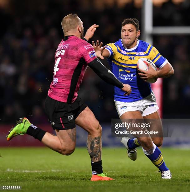 Ryan Hall of Leeds hands off Josh Griffin of Hull FC during the Betfred Super League match between Leeds Rhinos and Hull FC at Headingley Stadium on...