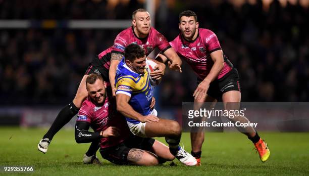 Ryan Hall of Leeds brought to ground by Josh Griffin, Dean Hadley and Jake Connor of Hull FC during the Betfred Super League match between Leeds...