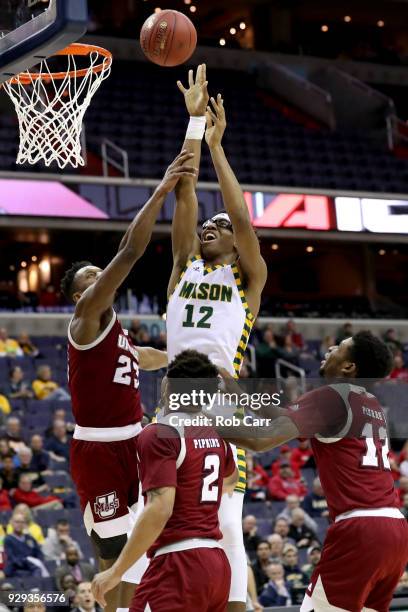 Wilson of the George Mason Patriots puts up a shot over C.J. Anderson of the Massachusetts Minutemen in the first half during the second round of the...