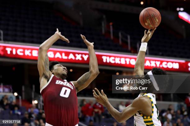 Wilson of the George Mason Patriots puts up a shot over Malik Hines of the Massachusetts Minutemen during the second round of the Atlantic 10...