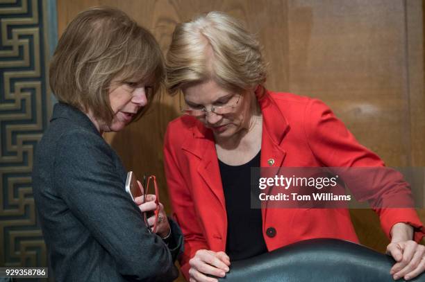 Sens. Elizabeth Warren, D-Mass., right, and Tina Smith, D-Minn., talk before a Senate Health, Education, Labor, and Pensions Committee hearing in...