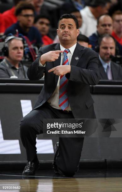Head coach Sean Miller of the Arizona Wildcats signals his players during a quarterfinal game of the Pac-12 basketball tournament against the...