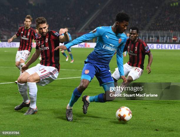 Ainsley Maitland-Niles of Arsenal holds off Fabio Borini of Milan of Milan during UEFA Europa League Round of 16 match between AC Milan and Arsenal...