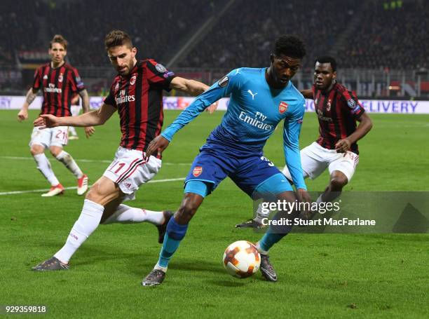 Ainsley Maitland-Niles of Arsenal holds off Fabio Borini of Milan of Milan during UEFA Europa League Round of 16 match between AC Milan and Arsenal...