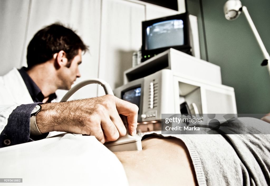 Doctor while performing an ultrasound to a patient