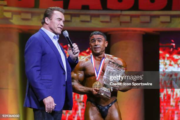 Arnold Schwarzenegger presents the first place trophy to Kamal Elgargni after Elgargni won the Arnold Classic 212 as part of the Arnold Sports...