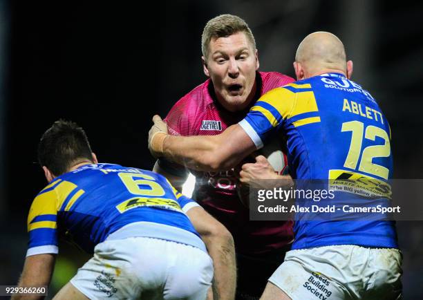 Hull FC 's Chris Green is tackled by Leeds Rhinos' Carl Ablett and Joel Moon during the Betfred Super League Round 5 match between Leeds Rhinos and...