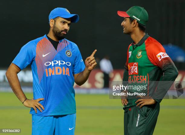 Indian cricket captain Rohit Sharma and Bangladesh cricket captain Mahmudullah Riyad are seen in a conversation during the 2nd T20 cricket match of...