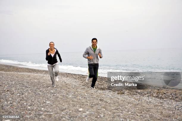 Couple Running On Beach.