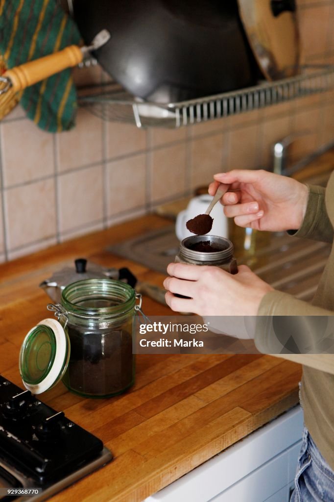 Woman In The Kitchen Preparing Coffee