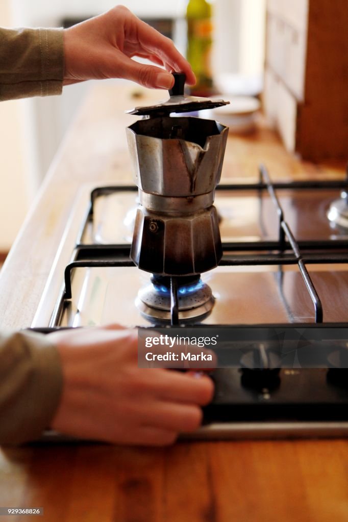 Woman In The Kitchen Preparing Coffee