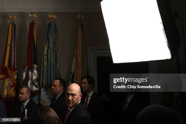 White House National Economic Council Director Gary Cohn joins journalists in the back of the Roosevelt Room as U.S. President Donald Trump signs the...