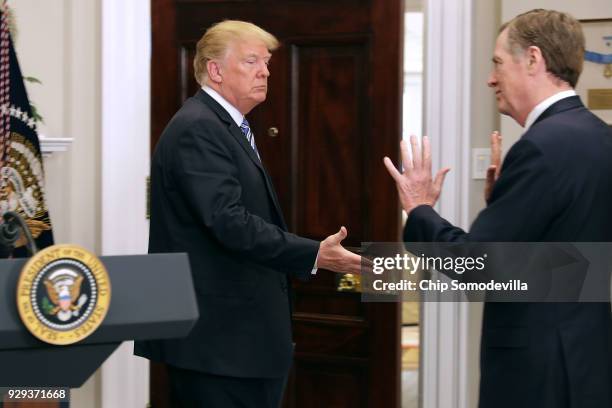 President Donald Trump attempts to shake hands with U.S. Trade Representative Robert Lighthizer after signing the 'Section 232 Proclamation' on steel...