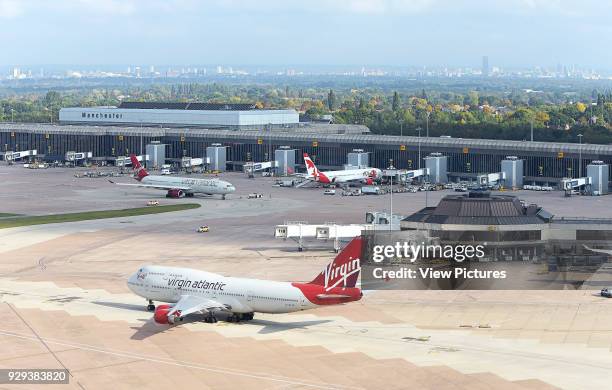 Elevated view of airport with Manchester cityscape beyond. Manchester Airport, Manchester, United Kingdom. Architect: n/a, 2015.