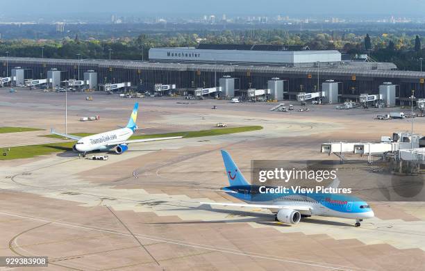 Elevated view of airport with Manchester cityscape beyond. Manchester Airport, Manchester, United Kingdom. Architect: n/a, 2015.