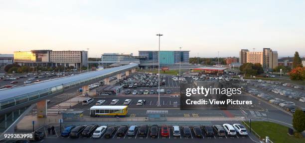 Panoramic elevation of terminal and car park with Skylink Walkway. Manchester Airport, Manchester, United Kingdom. Architect: n/a, 2015.