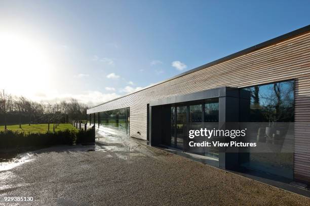 Orchard Spa, Coln Lakes, United Kingdom. Architect: De Matos Ryan, 2013. Perspective along timber clad main entrance.