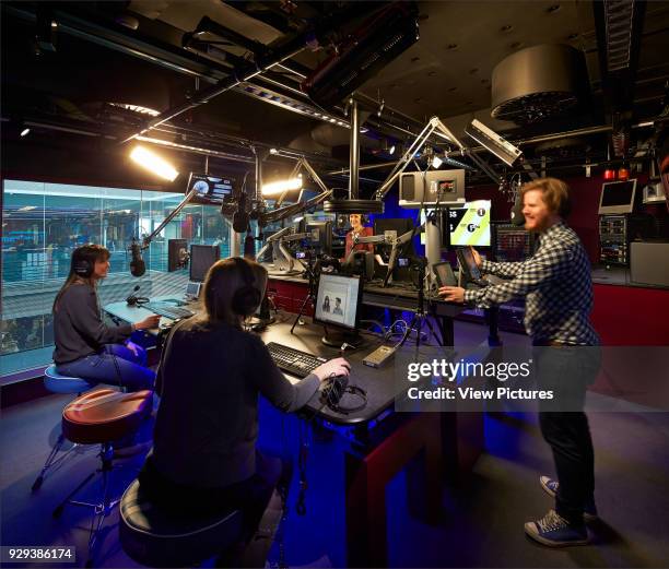 Broadcasting House, London, United Kingdom. Architect: HOK International Ltd, 2014. Radio 1 studio with journalists and technicians.