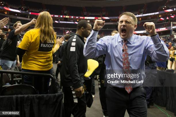 Head coach Mike Rhoades of the Virginia Commonwealth Rams celebrates as he walks off the court against the Dayton Flyers in the second round of the...