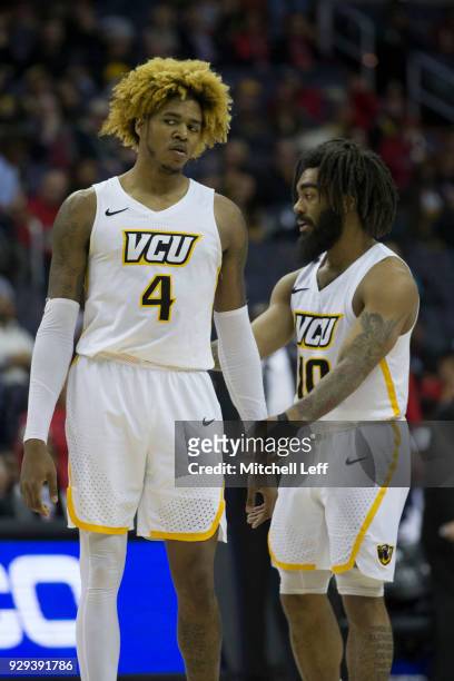 Justin Tillman and Jonathan Williams of the Virginia Commonwealth Rams talk to one another against the Dayton Flyers in the second round of the...