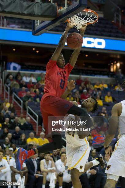 Kostas Antetokounmpo of the Dayton Flyers dunks the ball against Khris Lane of the Virginia Commonwealth Rams in the second round of the Atlantic 10...