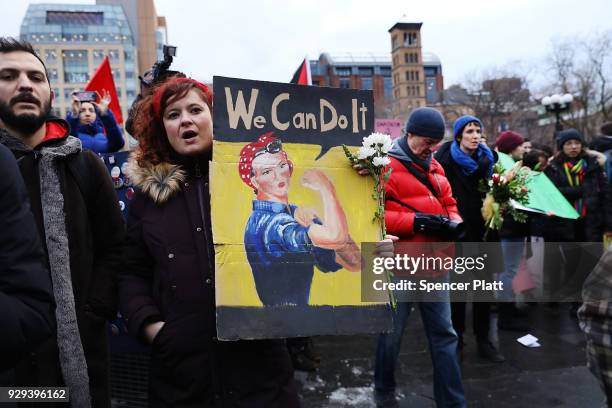 Dozens of women and men attend a rally and march in Washington Square Park for international Women's Day on March 8, 2018 in New York City. Around...