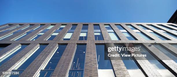 Facade viewed from below. MMU Student Union, Manchester, United Kingdom. Architect: Feilden Clegg Bradley Studios LLP, 2015.