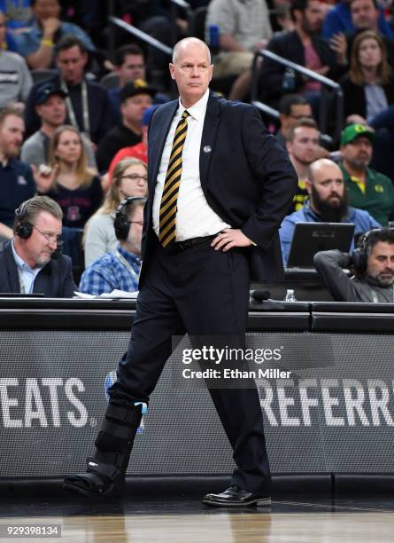 Head coach Tad Boyle of the Colorado Buffaloes wears a walking boot during a quarterfinal game of the Pac-12 basketball tournament against the...