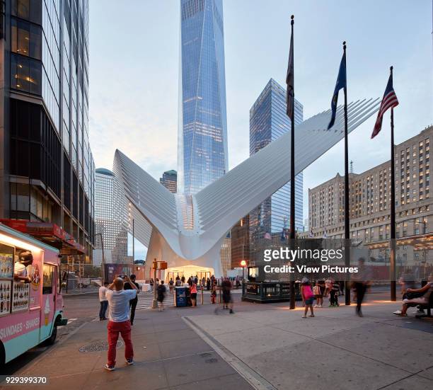 Street scene with Oculus entrance at dusk. The Oculus, World Trade Center Transportation Hub, New York, United States. Architect: Santiago Calatrava,...