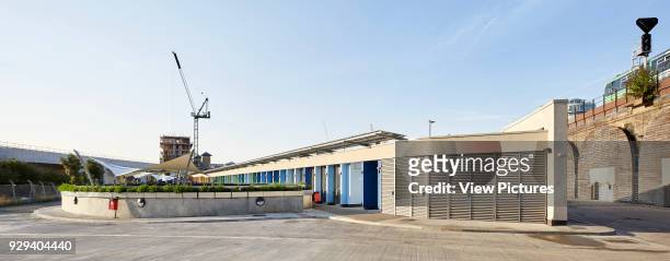 Panoramic elevation of circulation yard with kennel buildings. Battersea Dogs & Cats Home, London, United Kingdom. Architect: Jonathan Clark...