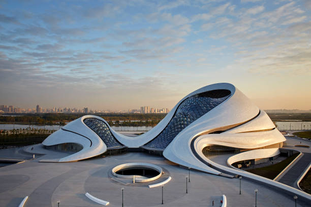 Aerial view of opera house with Harbin's skyline in background. Harbin Opera House, Harbin, China. Architect: MAD Architects, 2015.