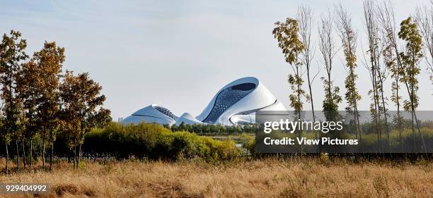 Distant view towards opera across wetland. Harbin Opera House, Harbin, China. Architect: MAD Architects, 2015.