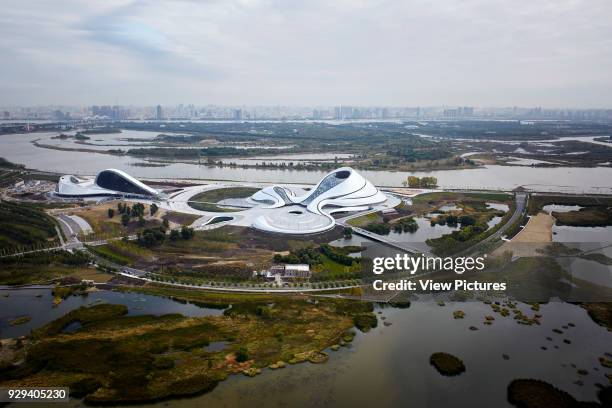 Aerial view of opera house embedded in Harbin's wetland landscape. Harbin Opera House, Harbin, China. Architect: MAD Architects, 2015.