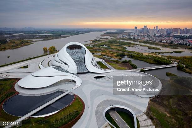 Aerial view of opera house embedded in Harbin's wetland with Songhua River. Harbin Opera House, Harbin, China. Architect: MAD Architects, 2015.